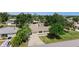Aerial view of the home featuring a well-manicured lawn and mature trees at 2126 Hanby St, Port Charlotte, FL 33952