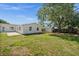 Lush backyard with green grass, a storage shed, and an attached patio, great for outdoor activities at 2126 Hanby St, Port Charlotte, FL 33952