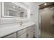 Bright bathroom features a large illuminated mirror, vanity and shower stall at 2126 Hanby St, Port Charlotte, FL 33952