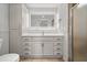 Bathroom featuring white vanity with gold hardware, a lighted mirror, and walk-in shower at 2126 Hanby St, Port Charlotte, FL 33952