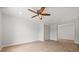 Cozy bedroom with ceiling fan, closet, and wood-look floors at 2126 Hanby St, Port Charlotte, FL 33952