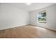 Bedroom featuring a window view of the lawn, and wood-look flooring at 2126 Hanby St, Port Charlotte, FL 33952