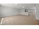 Bright living room with light wood flooring, neutral walls, and an open layout to kitchen at 2126 Hanby St, Port Charlotte, FL 33952