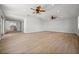 Large, bright living room with vaulted ceiling, ceiling fans, and wood-look floors at 2126 Hanby St, Port Charlotte, FL 33952