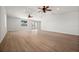 Open living room featuring new vinyl floors, ceiling fans, recessed lights, and a glass sliding door at 2126 Hanby St, Port Charlotte, FL 33952