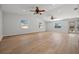 Large living room featuring vinyl floors, multiple ceiling fans, and lots of natural light at 2126 Hanby St, Port Charlotte, FL 33952