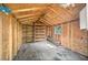 Interior view of the shed with wood paneling, shelving, and a ceiling fan, providing ample storage space at 2126 Hanby St, Port Charlotte, FL 33952
