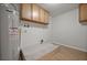 Utility room featuring a hot water tank, wooden cabinets, and vinyl floors at 2126 Hanby St, Port Charlotte, FL 33952