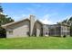 Home backyard featuring a screened-in pool and well-maintained lawn, perfect for outdoor enjoyment at 4266 Candler Ave, Spring Hill, FL 34609