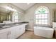 Elegant bathroom featuring a soaking tub, granite counters, and a unique stained-glass window at 4266 Candler Ave, Spring Hill, FL 34609