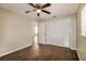 Cozy bedroom with wood-look flooring, a ceiling fan, and closet space at 4266 Candler Ave, Spring Hill, FL 34609