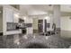 Modern kitchen features granite countertops, stainless appliances, and mosaic backsplash at 4266 Candler Ave, Spring Hill, FL 34609