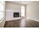 Living room with painted stone fireplace with windows, and wood laminate flooring at 4266 Candler Ave, Spring Hill, FL 34609