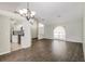 Bright living area featuring wood floors and a pass-through to the updated kitchen at 4266 Candler Ave, Spring Hill, FL 34609