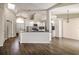 Open layout of the living and kitchen space with new cabinetry and granite countertops at 4266 Candler Ave, Spring Hill, FL 34609