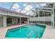 Inviting pool area with a screened enclosure and a sparkling blue pool, perfect for summer fun at 4266 Candler Ave, Spring Hill, FL 34609