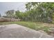 Spacious backyard with grass and partial concrete patio at 5429 Flora Ave, Holiday, FL 34690