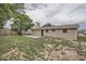 Spacious backyard featuring a concrete patio, secure fencing, and ample green space, ideal for recreation at 5429 Flora Ave, Holiday, FL 34690