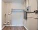 Unfinished basement space with wood-look floors and exposed piping at 5429 Flora Ave, Holiday, FL 34690