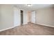 Bedroom featuring hardwood floors, closet, and two doors at 5429 Flora Ave, Holiday, FL 34690