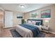 Cozy bedroom with blue accents, two windows, and hardwood floors at 5429 Flora Ave, Holiday, FL 34690