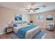 Staged bedroom with modern décor, blue accents, and wood flooring at 5429 Flora Ave, Holiday, FL 34690