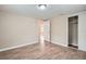 Bright bedroom with wood-look flooring, closet, and natural light at 5429 Flora Ave, Holiday, FL 34690
