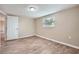 Bedroom features wood-look flooring, neutral walls, and one window at 5429 Flora Ave, Holiday, FL 34690