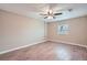 Bright bedroom featuring new wood floors and a ceiling fan at 5429 Flora Ave, Holiday, FL 34690