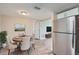 Dining room features a round table with seating, adjacent to stainless steel refrigerator at 5429 Flora Ave, Holiday, FL 34690