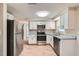 Well-lit kitchen boasts modern stainless steel appliances and granite countertops at 5429 Flora Ave, Holiday, FL 34690