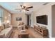 Staged living room with a ceiling fan, modern furniture, and wood flooring at 5429 Flora Ave, Holiday, FL 34690