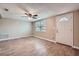 Living room features new wood flooring, a ceiling fan, and a bright window at 5429 Flora Ave, Holiday, FL 34690