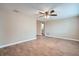 Spacious living room with wood-look floors and a ceiling fan, offering access to the kitchen at 5429 Flora Ave, Holiday, FL 34690