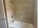 Bright bathroom with a shower and tub featuring neutral toned tile surround at 12421 Early Run Ln, Riverview, FL 33578