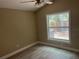 Bedroom with neutral walls, modern ceiling fan, wood-look flooring and natural light at 12421 Early Run Ln, Riverview, FL 33578