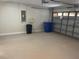 Garage featuring speckled flooring, ample storage and an open garage door at 12421 Early Run Ln, Riverview, FL 33578