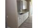 Kitchenette area with white cabinets and countertops, and light-colored flooring at 12421 Early Run Ln, Riverview, FL 33578