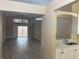 Bright living room with modern lighting, flooring, and views into kitchen and backyard at 12421 Early Run Ln, Riverview, FL 33578