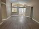 Open-concept living room featuring modern flooring and an entryway with a clear view of the front door at 12421 Early Run Ln, Riverview, FL 33578