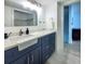 Bathroom featuring a vanity with marble countertop and open closet at 215 Medallion Blvd # G, Madeira Beach, FL 33708