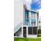 Blue and white condo building with sunny sky and blue accents on balconies and trim at 215 Medallion Blvd # G, Madeira Beach, FL 33708