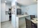 Open-concept kitchen with white cabinets, stainless steel appliances, and marble countertops at 215 Medallion Blvd # G, Madeira Beach, FL 33708