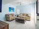 Comfortable living room with neutral sofa, love seat, and marble floors, great for entertaining at 215 Medallion Blvd # G, Madeira Beach, FL 33708