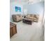 Light blue living room with comfortable seating, a ceiling fan, and bright, natural light at 215 Medallion Blvd # G, Madeira Beach, FL 33708