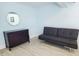 The living room has stylish black futon, dresser, and decorative mirror at 215 Medallion Blvd # G, Madeira Beach, FL 33708