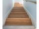 Staircase with wooden treads and white risers leads to the upper level at 215 Medallion Blvd # G, Madeira Beach, FL 33708