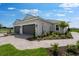 Home exterior featuring a two-car garage and driveway with manicured landscaping at 3142 Torta Ct, Bradenton, FL 34211