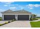 Charming home with a two car garage, paver driveway, and well manicured lawn at 3142 Torta Ct, Bradenton, FL 34211