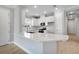Modern kitchen features a center island, white cabinetry, and stainless steel appliances at 3142 Torta Ct, Bradenton, FL 34211